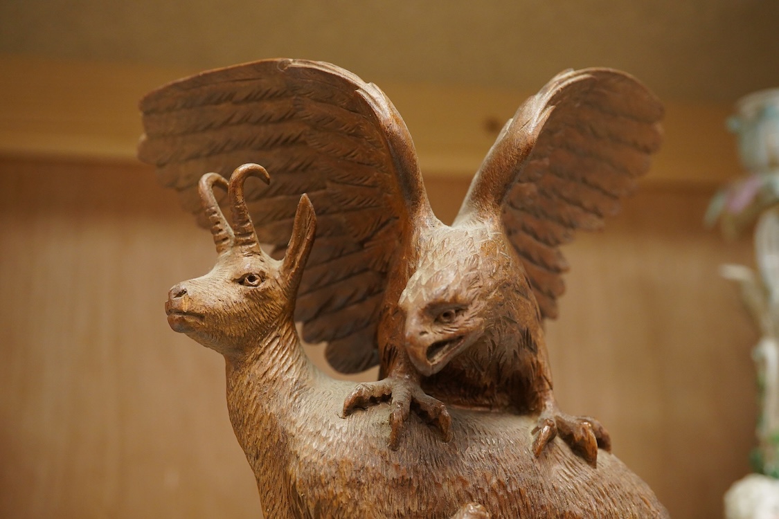 A late 19th century Black Forest carving, chamois group and eagle, 21cm
